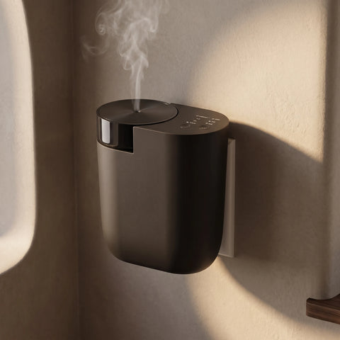 Black Contour Smart Plug-In waterless diffuser with white mist against a sunlit textured plaster wall