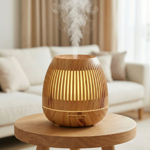 Light wood grain drum-shaped diffuser with slatted ventilation and warm LED on side table - Aroma Paradise