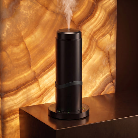 Black PowerFlow Tower waterless scent diffuser in a backlit amber onyx interior
