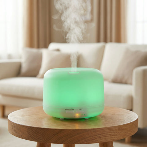 Rounded 350ml diffuser glowing green LED with cool mist on a wood side table - Aroma Paradise