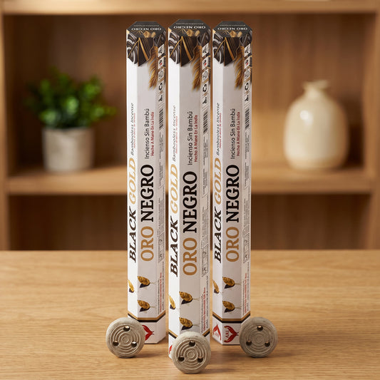Aum Black and Gold bambooless incense sticks 3-pack with 3 metal coil holders on light oak wood surface