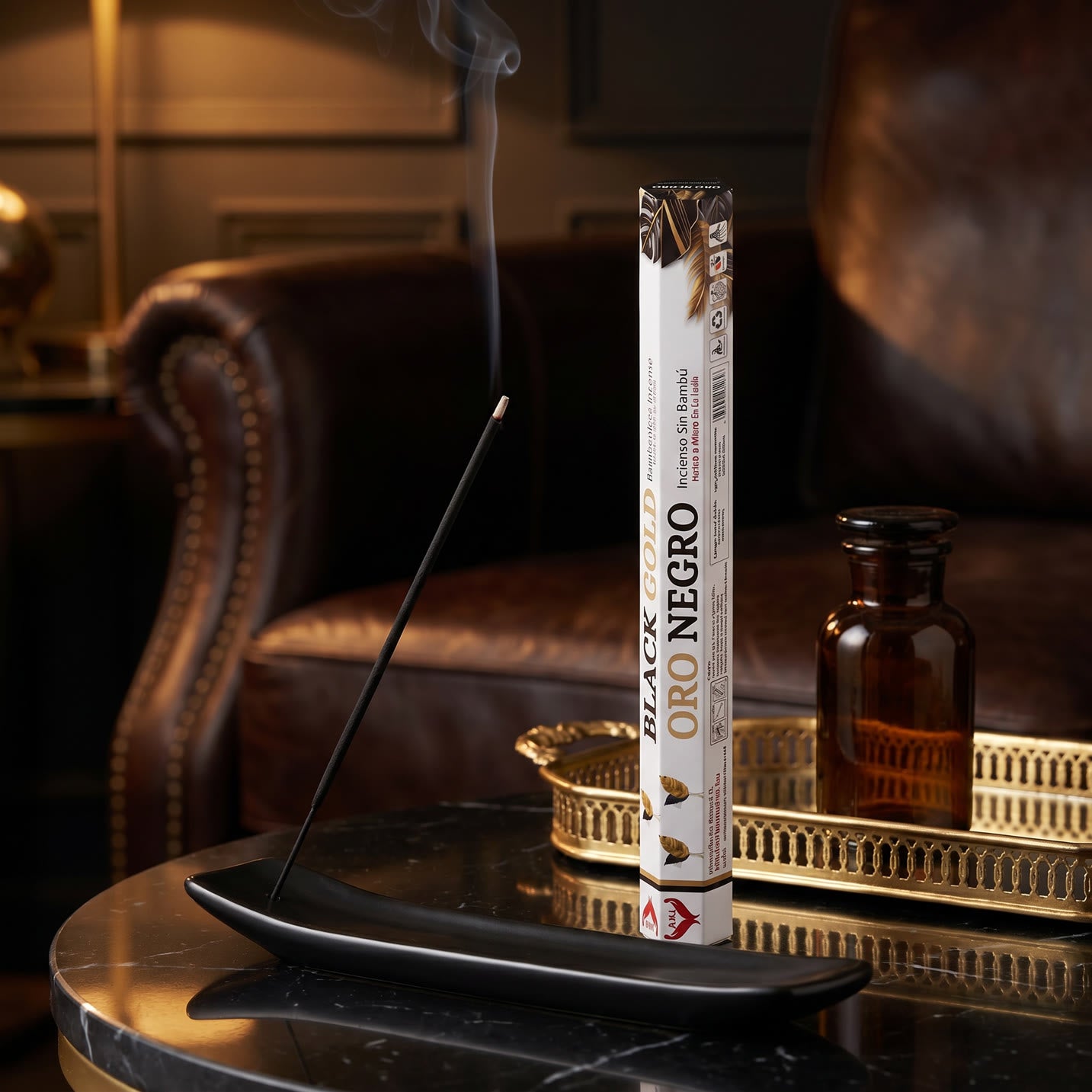 Aum Black and Gold bambooless incense stick burning in luxurious lounge with amber glass and gold tray