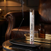 Aum Black and Gold bambooless incense stick burning in luxurious lounge with amber glass and gold tray