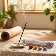 Aum Chakra bambooless incense stick burning in yoga room with colorful chakra healing stones