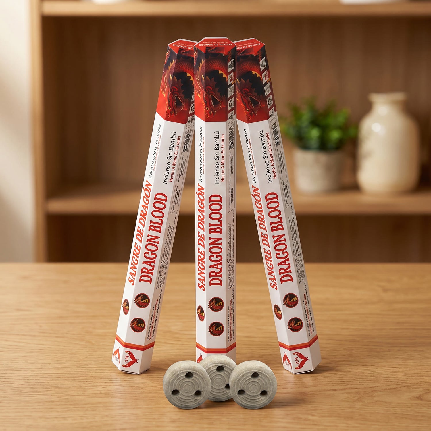 Aum Dragon Blood bambooless incense sticks 3-pack with 3 metal coil holders on light oak wood surface