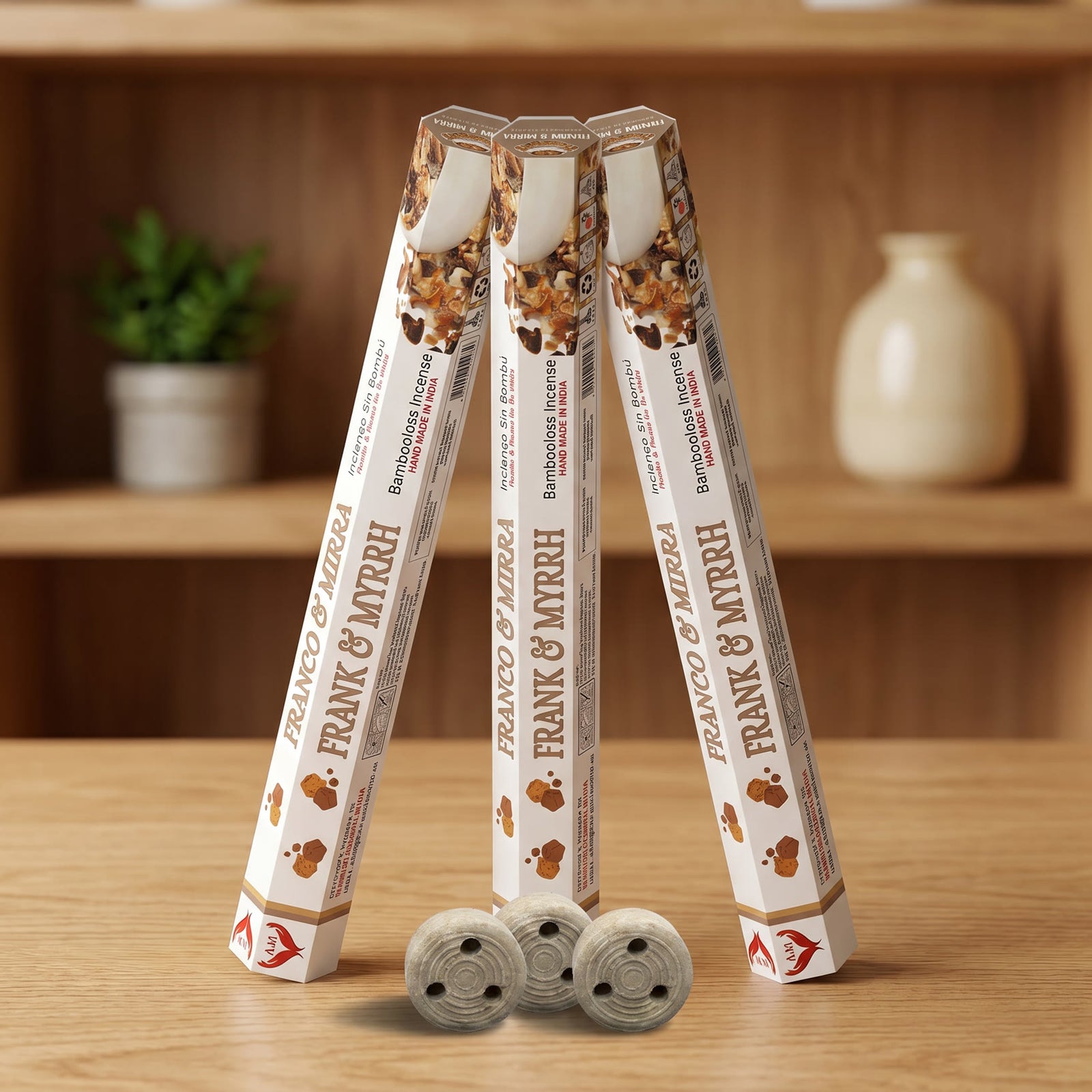 Aum Frank and Myrrh bambooless incense sticks 3-pack with 3 metal coil holders on light oak wood surface