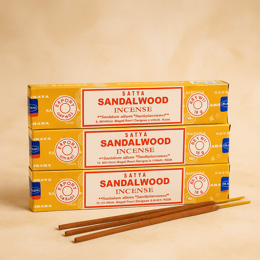 Three boxes of Satya Sandalwood Incense on a beige background