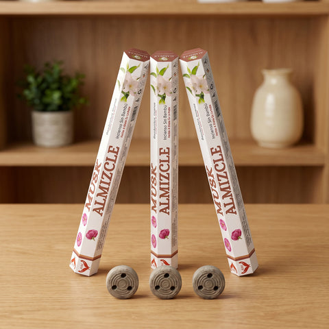 Aum Musk bambooless incense sticks 3-pack with 3 metal coil holders on light oak wood surface