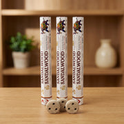 Aum Sandalwood bambooless incense sticks 3-pack with 3 metal coil holders on light oak wood surface