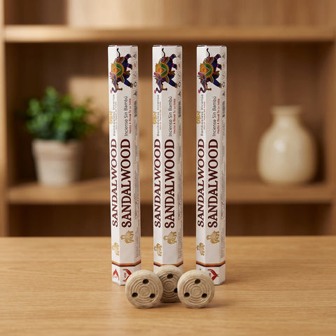 Aum Sandalwood bambooless incense sticks 3-pack with 3 metal coil holders on light oak wood surface