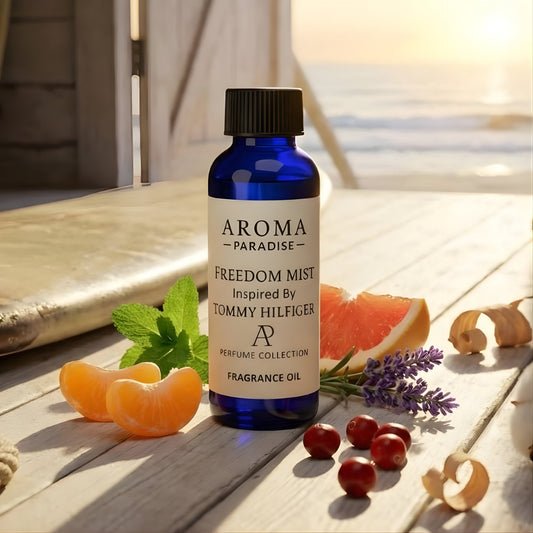 Bottle of Aroma Paradise Freedom Mist perfume on a wooden surface with fruits and plants.