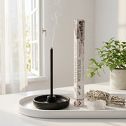 Aum White Sage bambooless incense stick burning in sunlit room with dried sage bundle and selenite crystal