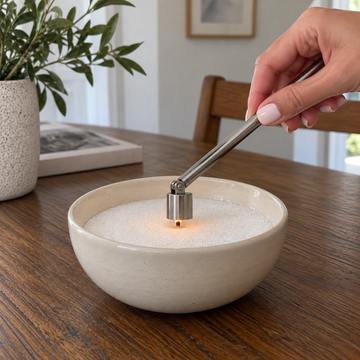 Extinguishing a candle sand flame with a snuffer