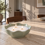 Candle sand in a scalloped bowl on a dining table