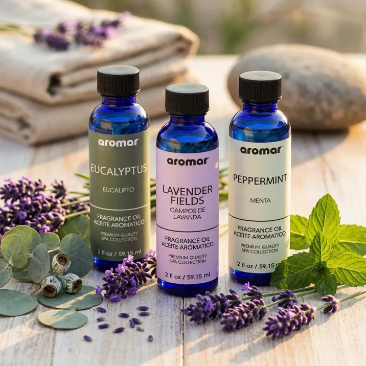 Three blue bottles of Eucalyptus Lavender and Peppermint aromatherapy oils with fresh herbs, Aroma Paradise