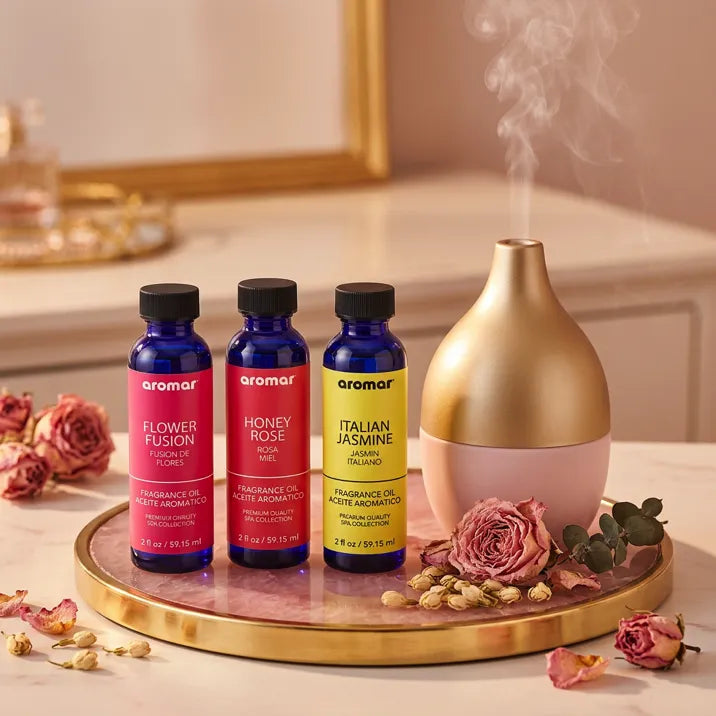 Floral oil set with gold diffuser misting on pink marble tray with dried roses on elegant vanity, Aroma Paradise