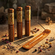 Hem Egyptian Musk incense tubes with smoking stick in wooden holder on sandstone with dried petals - Aroma Paradise