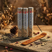 Hem White Sage incense tubes with smoking stick in wooden holder on stone with dried herbs - Aroma Paradise