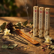 Hem French Vanilla incense tubes with smoking stick in wooden holder on stone with vanilla flowers - Aroma Paradise