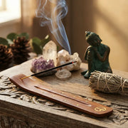 Smoking incense in wooden peace sign holder with Buddha statue, crystals, and sage bundle - Aroma Paradise