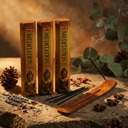 Three gold Hem Meditation boxes with Buddha design, wooden holder, and sticks on stone with star anise - Aroma Paradise