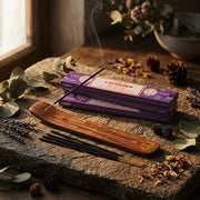 Purple Satya Lavender incense boxes with smoking stick on wooden holder on stone surface - Aroma Paradise