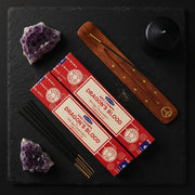 Satya Dragon Blood gift set flat lay with three red boxes, wooden holder, amethyst crystals on black slate - Aroma Paradise