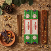 Satya Patchouli incense boxes with wooden holder and sticks on jute surface with dried botanicals - Aroma Paradise