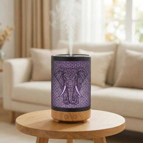Elephant Metal Diffuser with purple LED elephant shadow pattern and wood base misting in living room - Aroma Paradise