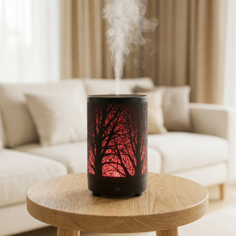 Forest Metal Diffuser with red LED tree branch shadow pattern and black body misting in living room - Aroma Paradise