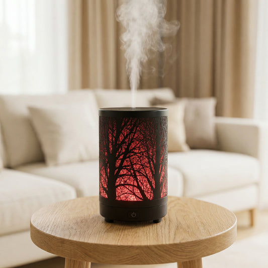 Forest Metal Diffuser with red LED tree branch shadow pattern and black body misting in living room - Aroma Paradise