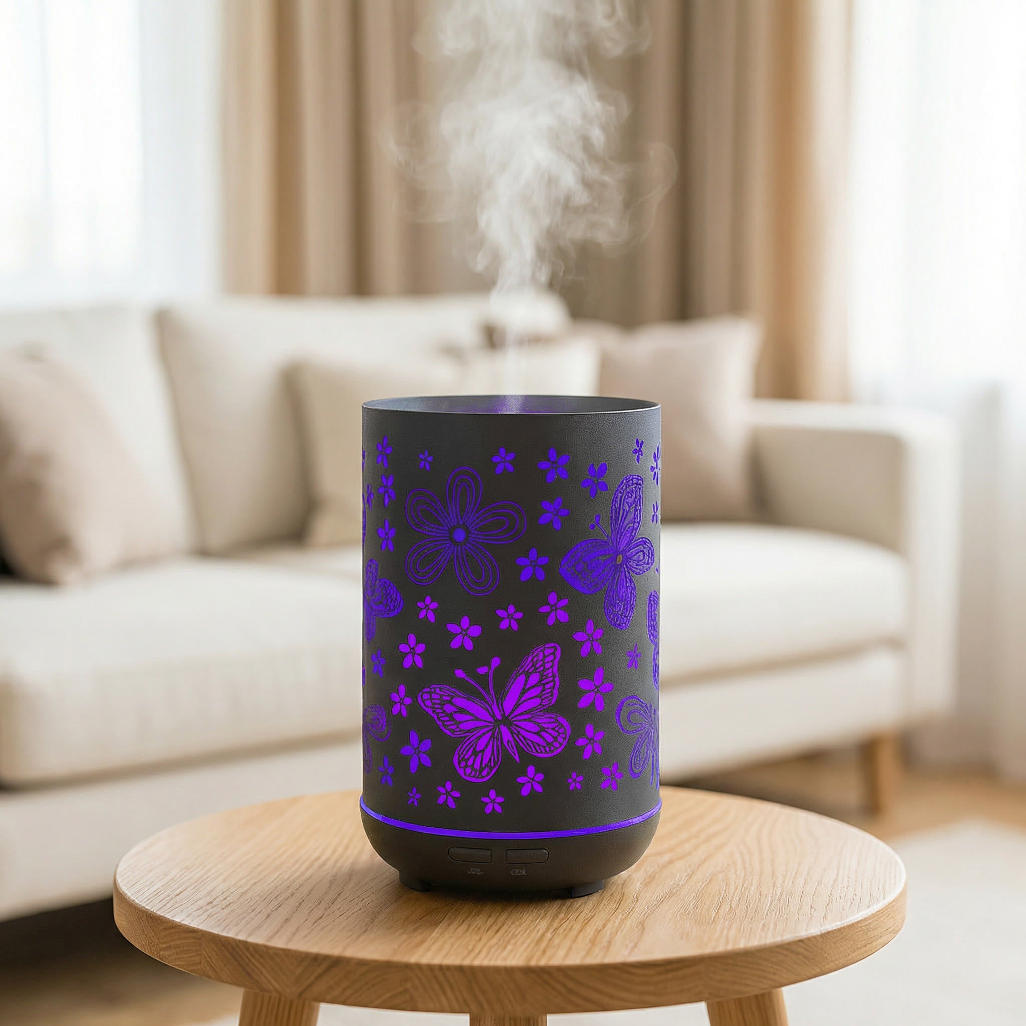 Black metal diffuser with purple LED butterfly and flower cutout patterns misting on wood table, Aroma Paradise