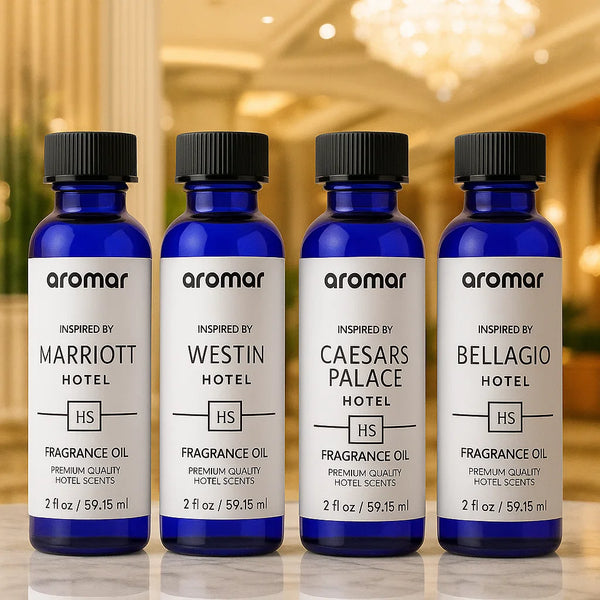 Four bottles of Aromar fragrance oil inspired by famous hotels on a blurred background.