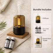 Aroma therapy diffuser set with oils and quick-start guide on a neutral background