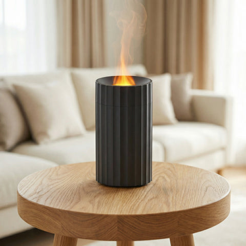 Black ribbed cylindrical Pillar Flame Diffuser with orange flame effect on top in cozy living room - Aroma Paradise